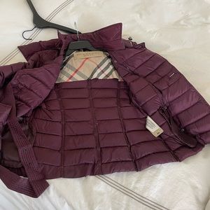 Burberry puffer with hood and belt.